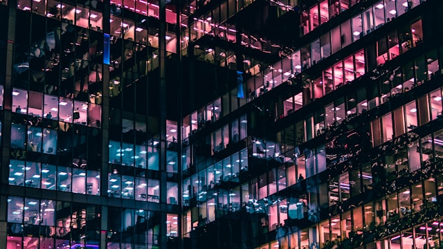windows on a building lit up at night